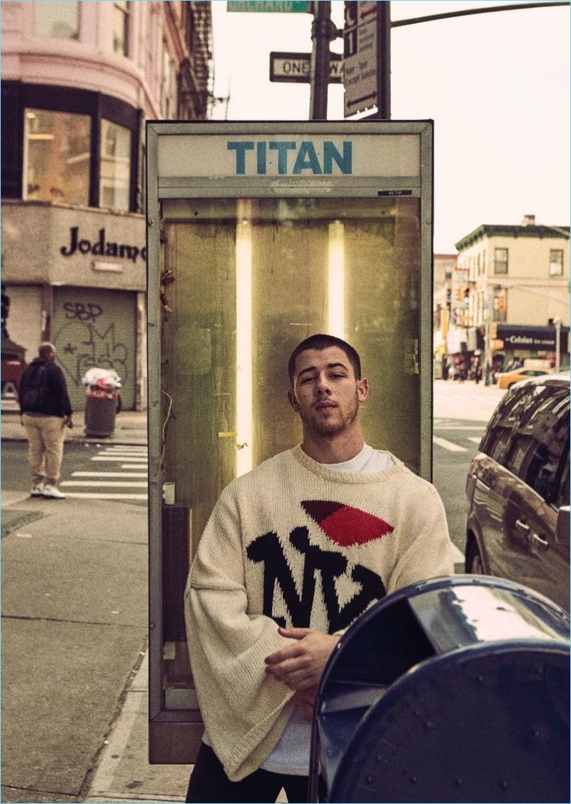 Venturing outdoors, Nick Jonas wears a Raf Simons NY sweater.