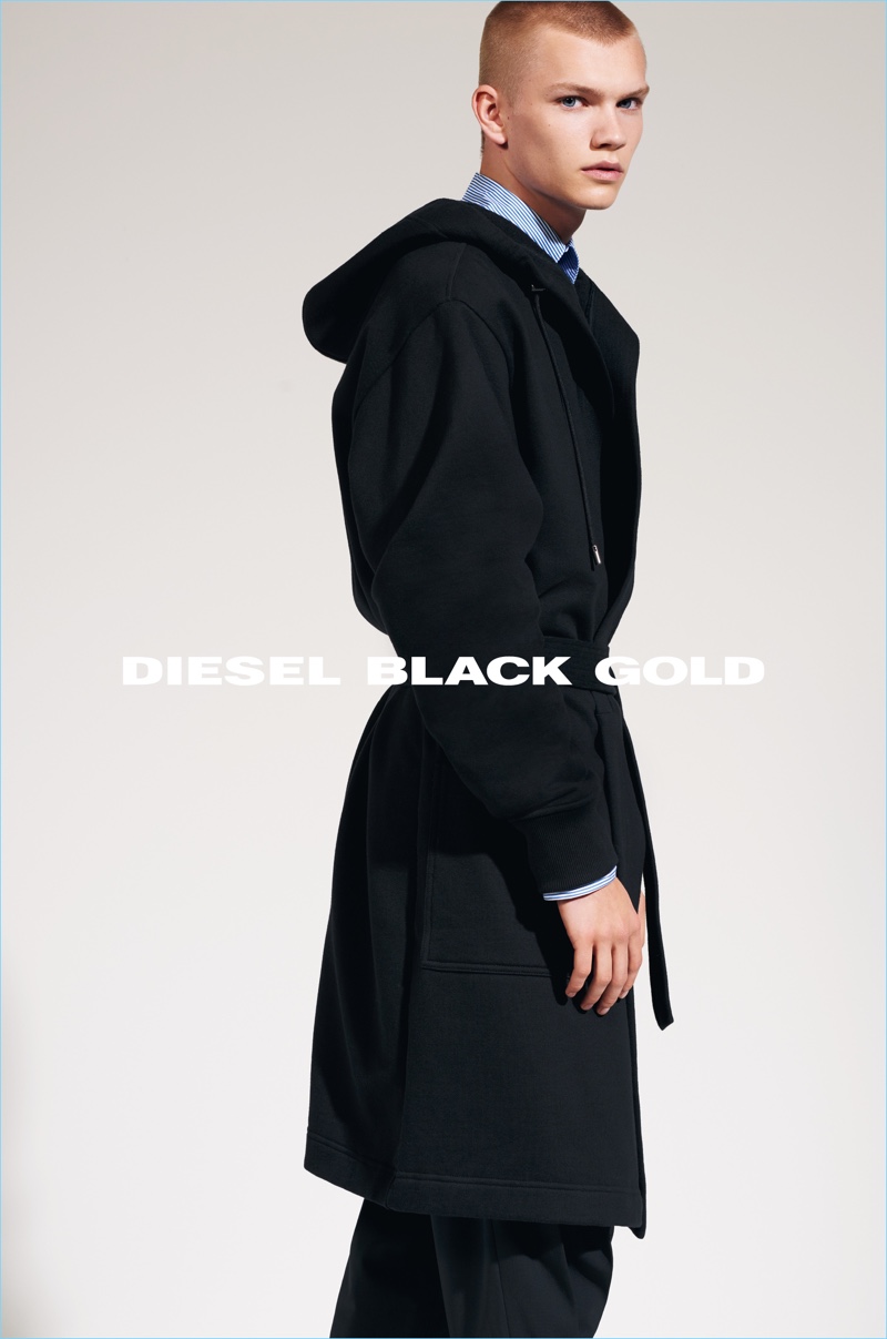 Model Jordy Gerritsma dons a sleek long coat for Diesel Black Gold's fall-winter 2017 campaign.