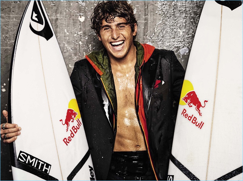 All smiles, Leonardo Fioravanti wears a Tagliatore blazer with a hooded K-Way jacket, and Quiksilver wetsuit.