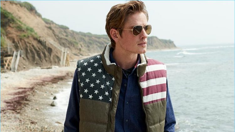 Connecting with Macy's, Patrick O'Donnell wears a flag quilted vest with Ray-Ban sunglasses.