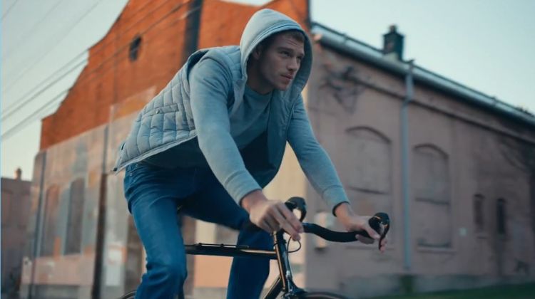 American model Matthew Noszka rides a bike in Express' Tough denim jeans.