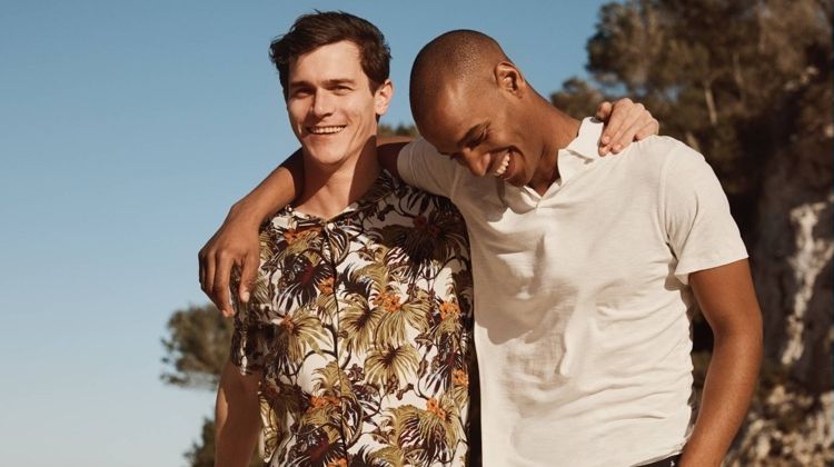 Left to Right: Vincent LaCrocq wears a tropical print shirt with chino shorts by H&M. Sasha M'Baye sports a white H&M polo shirt with palm tree print chino shorts.