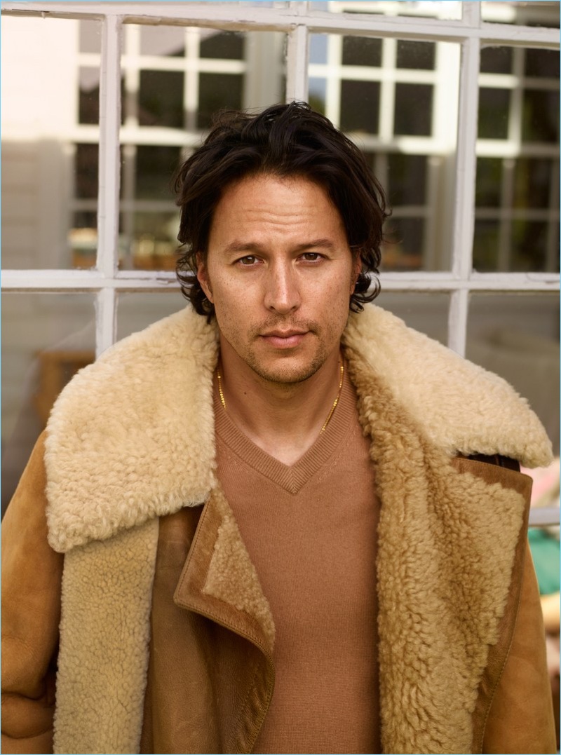 Director Cary Fukunaga sports an Alexander McQueen shearling coat, Joseph sweater, and David Yurman necklace.