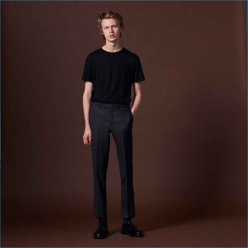 Jonas Glöer sports a tailored pair of wool suit trousers by Sandro.