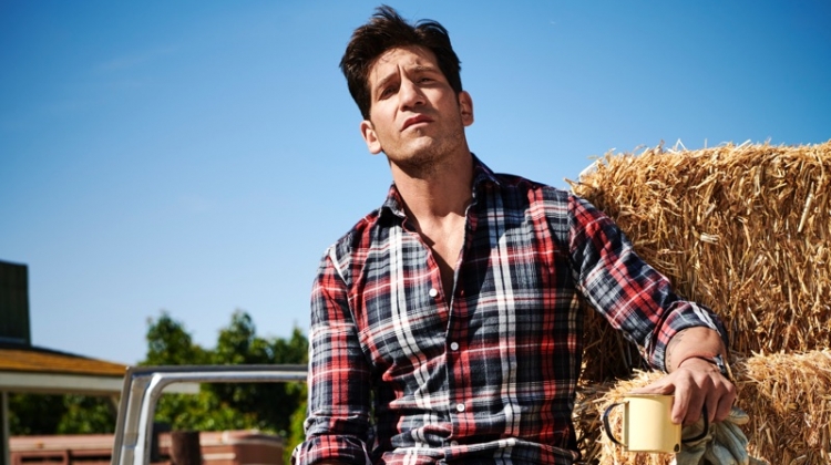 Embracing rugged style, Jon Bernthal wears an Eleventy shirt, Dolce & Gabbana jeans, Allen Edmonds boots, and a Movado watch.