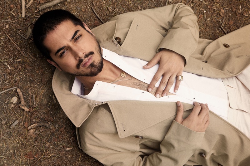 Starring in a new photo shoot, Avan Jogia sports a H&M trench with a SCYLT shirt, COS trousers, and a ring by Topman.