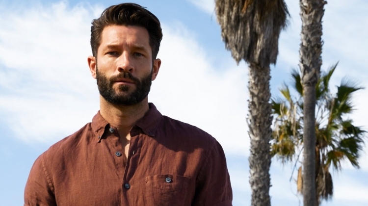 John Halls sports a brown Todd Snyder short-sleeve linen button-down shirt with Hartford Hawaiian surf print swim trunks.