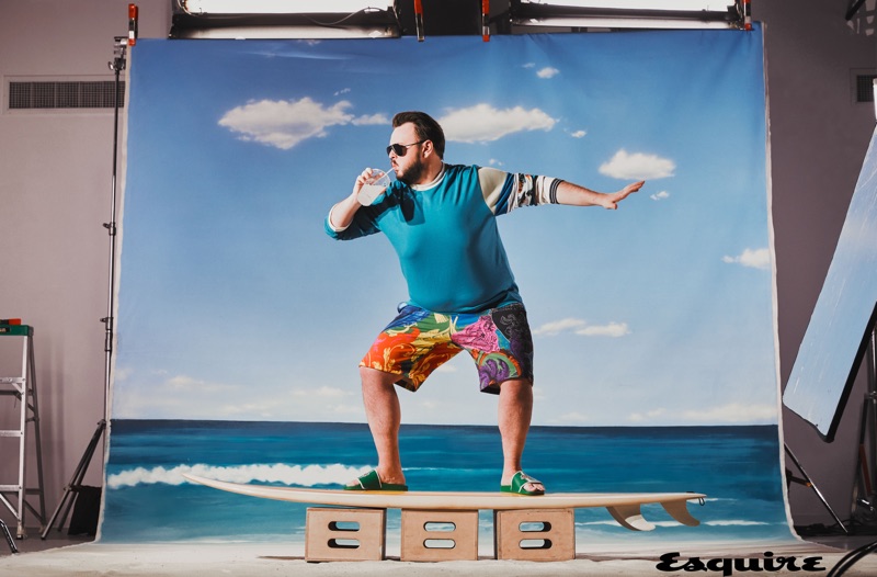 Ready to catch a wave, John Bradley sports Dolce & Gabbana sunglasses, an Acne Studios shirt, Versace shorts, and Le Tigre sandals.