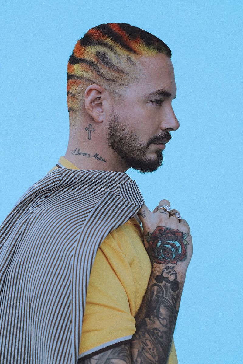 Music artist J Balvin sports a Fendi shirt and suit jacket.