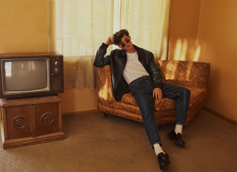 Channeling a '50s greaser look, Gabriel Jayne dons a leather jacket with a white t-shirt, denim jeans, and black loafers by Zara.