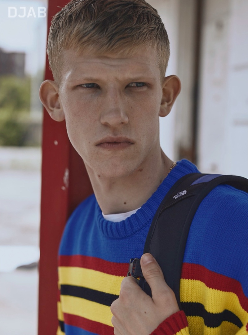 Connor Newall models a colorful DJAB sweater with a backpack by The North Face.