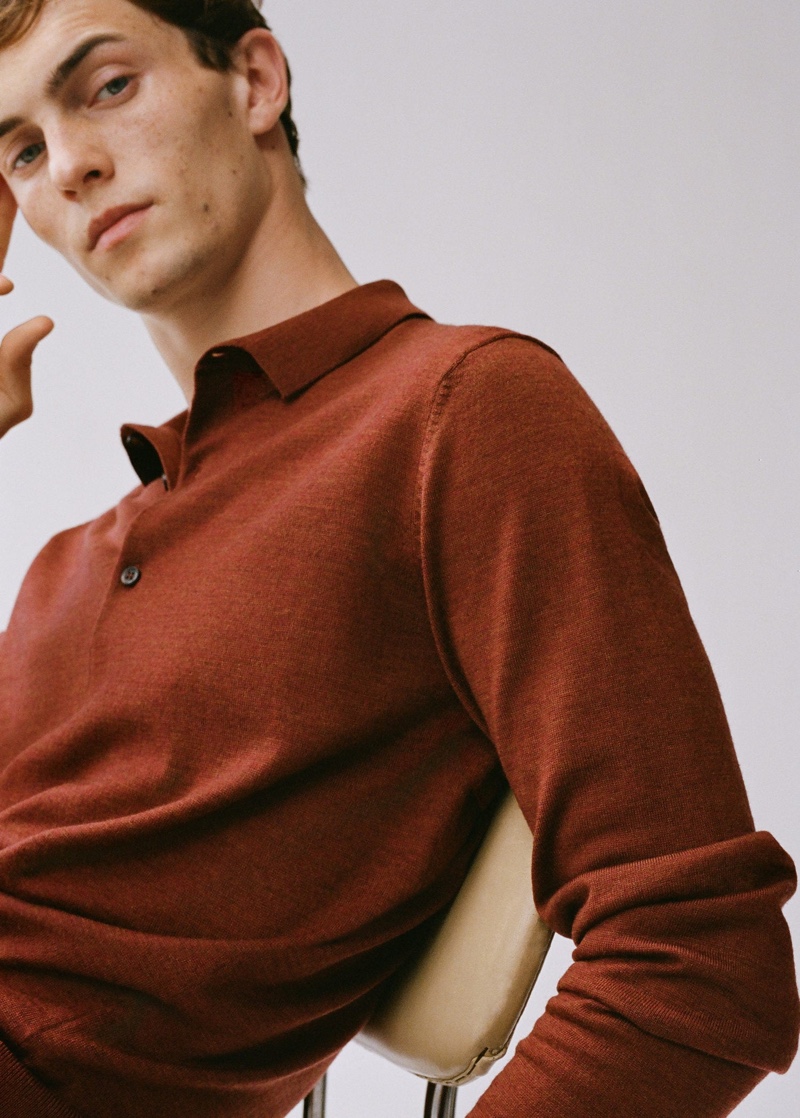 Model Luc Defont-Saviard dons a long-sleeve polo by Mango.