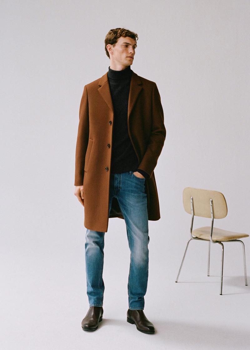 Going smart casual, Luc Defont-Saviard dons a single-breasted coat with a turtleneck sweater and distressed denim jeans from Mango.