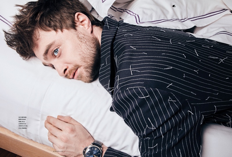 Laying in bed, Daniel Radcliffe wears a pinstripe jacket by Michael Kors for Esquire México.