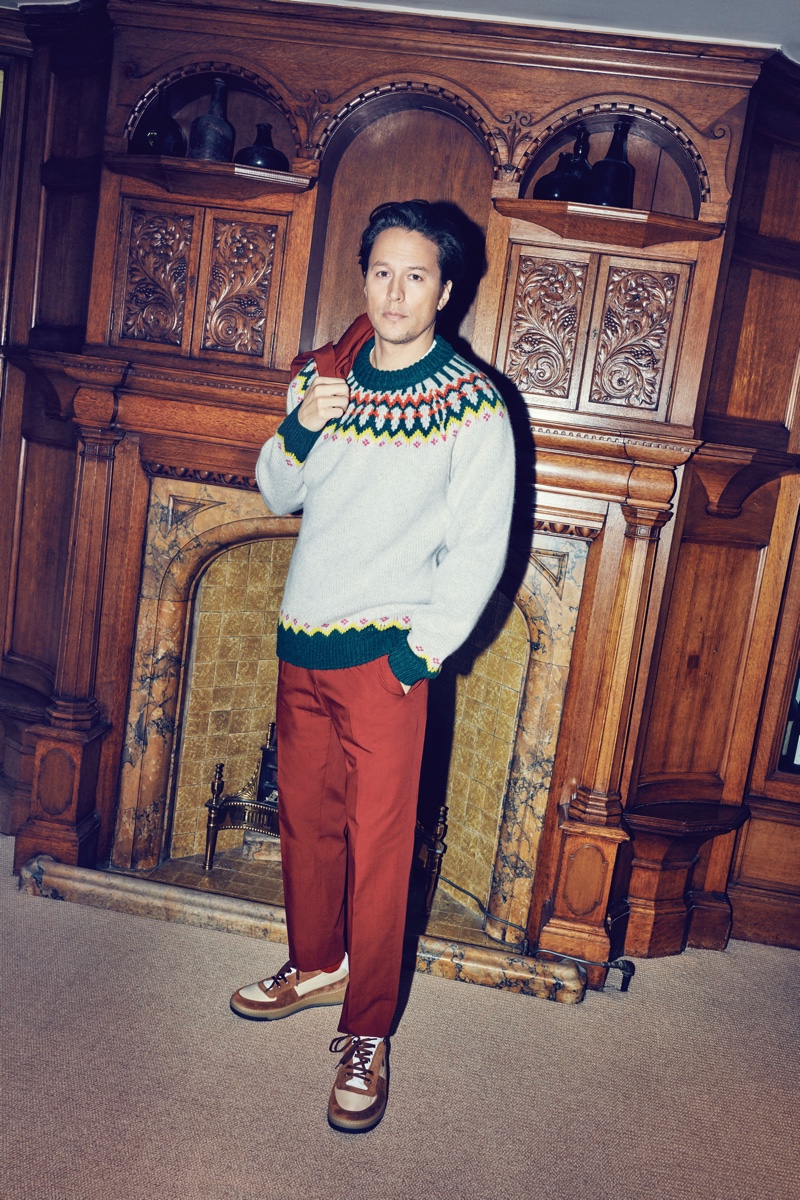 Front and center, Cary Joji Fukunaga wears a Dries Van Noten brick red suit, Burberry fair isle wool sweater, and Acne Studios sneakers.