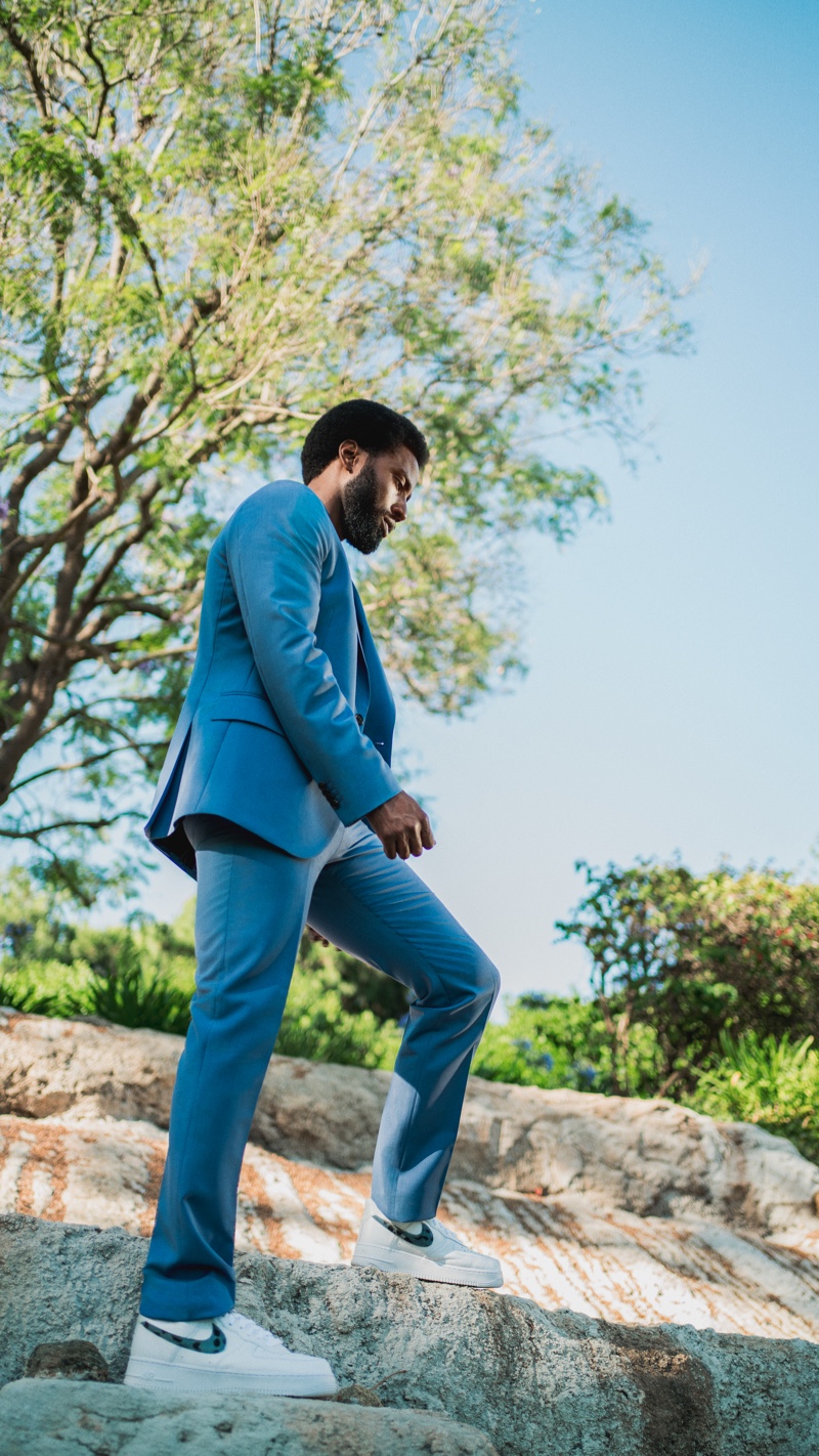 Sporting a sharp Paul Smith suit, John David Washington also wears a Save Khaki United t-shirt and Nike sneakers.