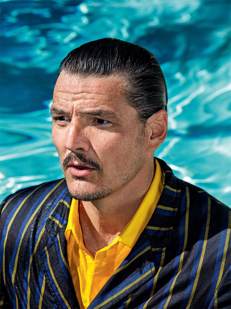 Relaxing poolside with GQ Germany, Pedro Pascal wears a pinstripe Lanvin suit with an Off-White shirt.