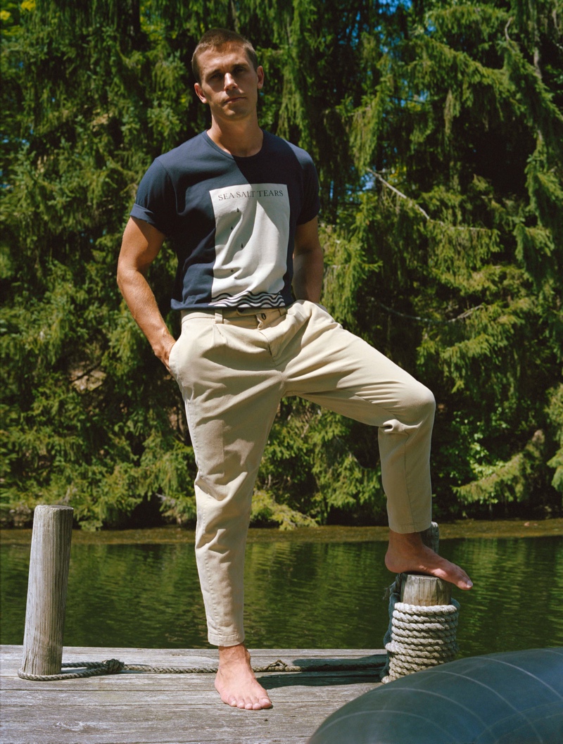 Pictured outdoors, Antoni Porowski dons The Easy Tee with pleated trousers from his J Brand collection.