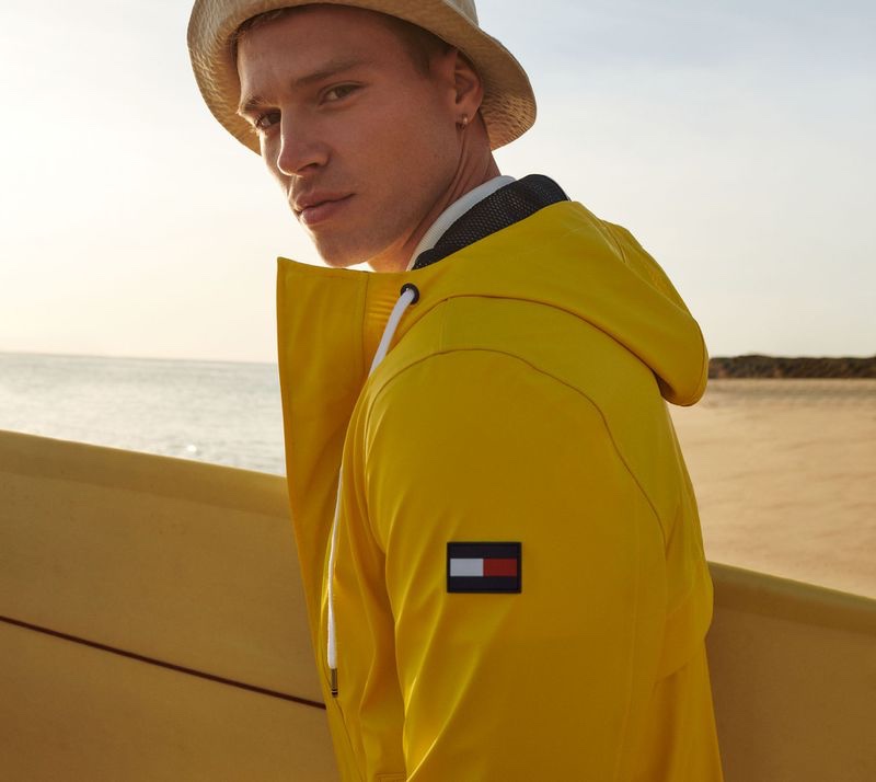 Sporting a yellow hooded jacket, Matthew Noszka fronts Tommy Hilfiger's spring-summer 2021 men's campaign.