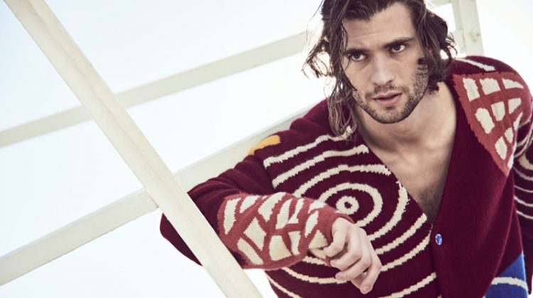 Connecting with Mytheresa for its spring-summer 2021 campaign, David Corenswet wears a chunky cardigan by The Elder Statesman.