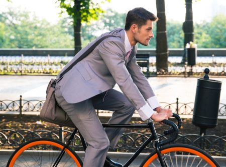 Man in Suit Riding Bike