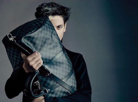 Model Takfarines Bengana pictured with Louis Vuitton's keepall bag in its Damier print.