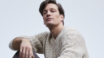 Florian Van Bael takes up the spotlight in a v-neck cable-knit sweater and trousers.