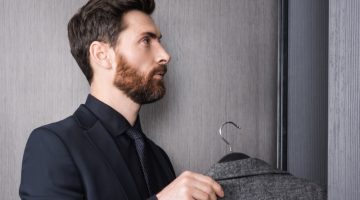 Man Putting Sport Coat in Closet Suit