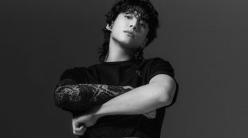 Jung Kook rocks a black Relaxed Fit Archive Logo Tee with Standard Straight Jeans for Calvin Klein's spring-summer 2023 campaign.