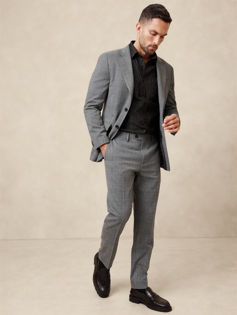 Elevate your style game with the sophisticated pairing of a Prince of Wales suit and a sleek black shirt.