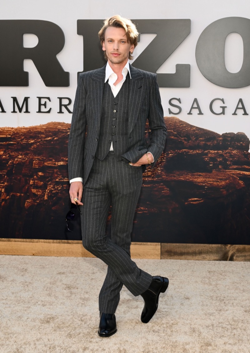 Actor Jamie Campbell Bower shows off the sartorial power of the grey three-piece pinstripe suit, wearing Tom Ford at the premiere of “Horizon: an American Saga.”