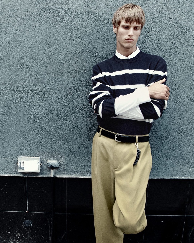 Yeray Allgayer models a striped sweater with cropped barrel-leg trousers.