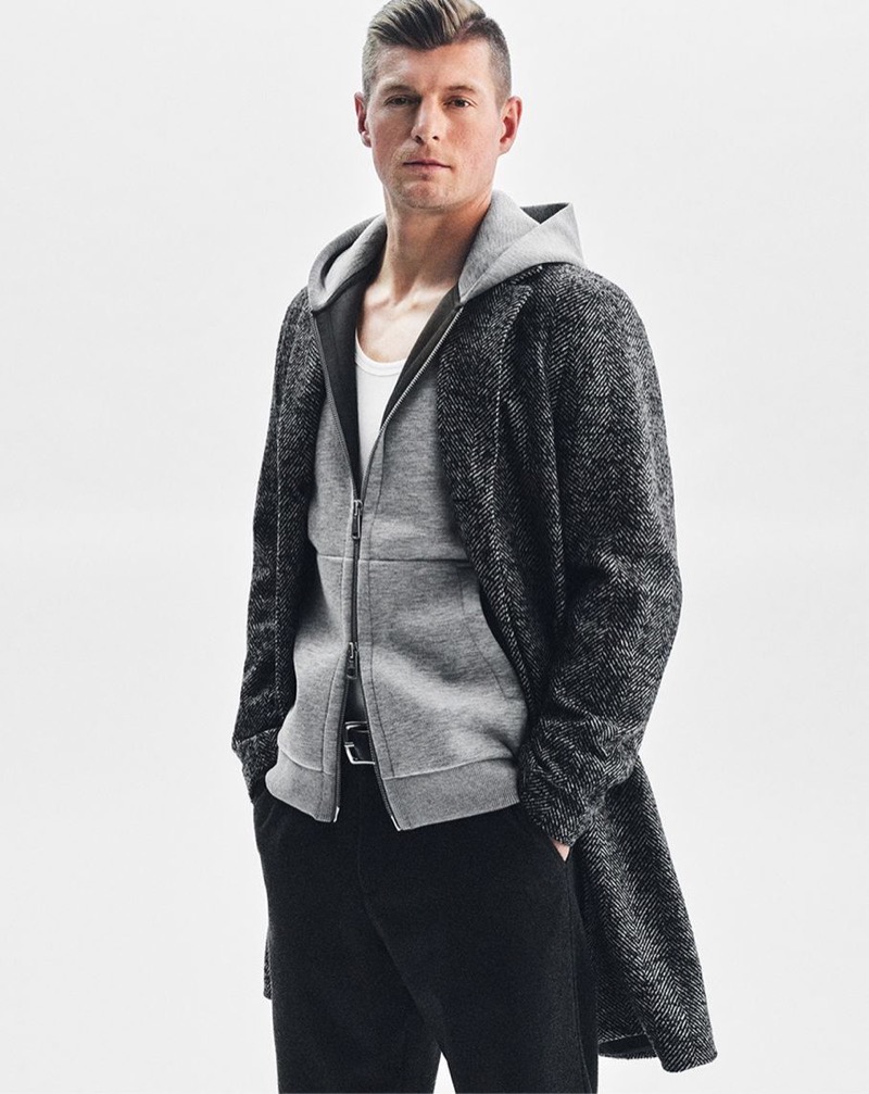 Toni Kroos wears a herringbone coat over a full-zip hoodie for Marc O’Polo’s fall-winter 2024 campaign.