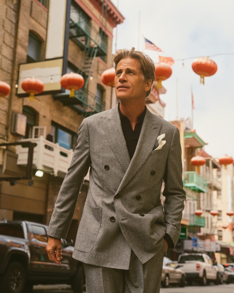 Mark Vanderloo wears a grey double-breasted suit for Banana Republic’s holiday 2024 campaign.